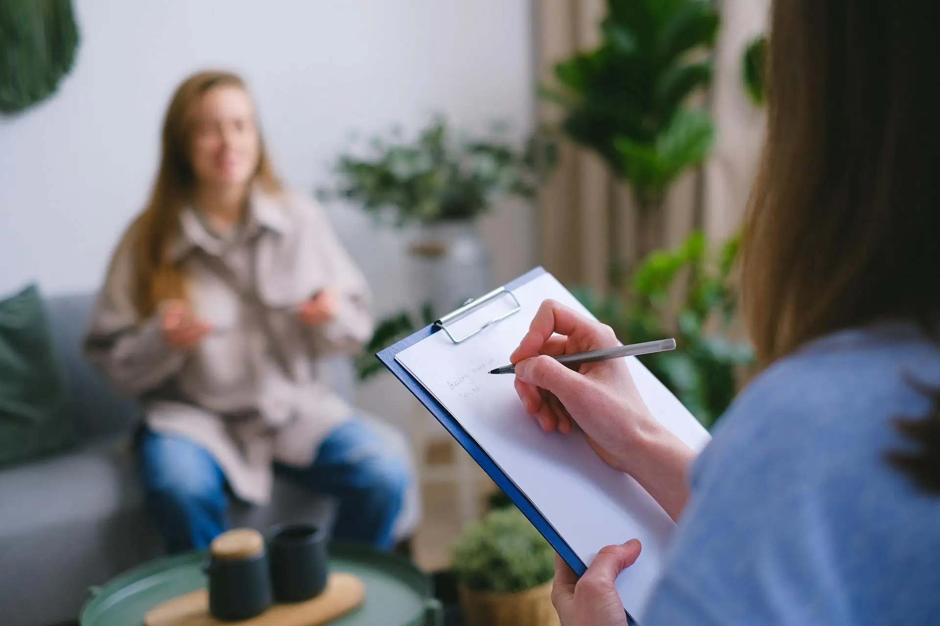 A women is taking note of a conversation